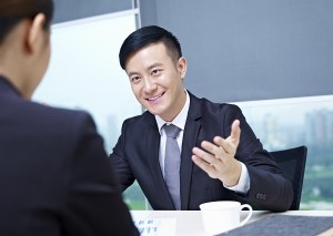 asian business executives having a discussion in office.